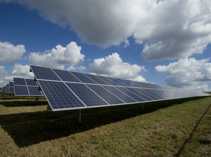 Large-scale ground-mount solar array at sunset